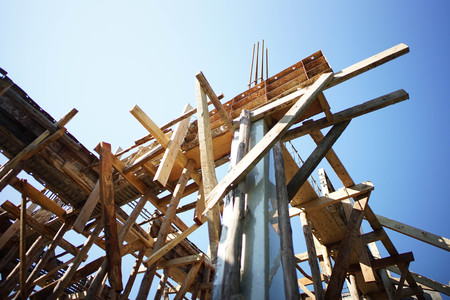 The wood support of the making reinforced steel concrete bar of the house under construction with the sunshine and clear sky in a hot day.の写真素材