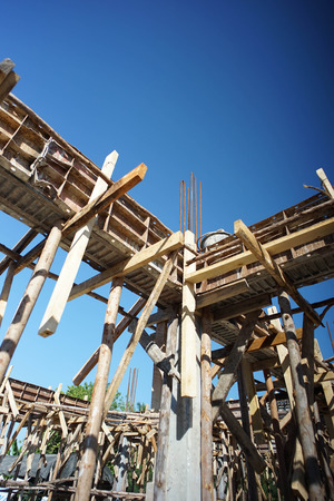 The wood support of the making reinforced steel concrete bar of the house under construction with the sunshine and clear sky in a hot day.の写真素材