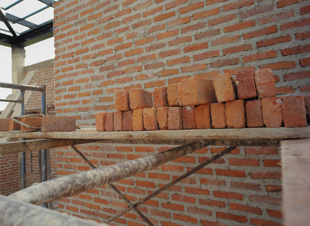 Texture and background of bricklayer and concrete wall at the house under constructionの写真素材
