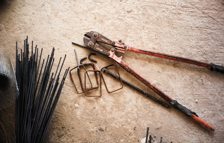 Steel wire cutter and reinforcement steel on the concrete floor at the construction siteの写真素材