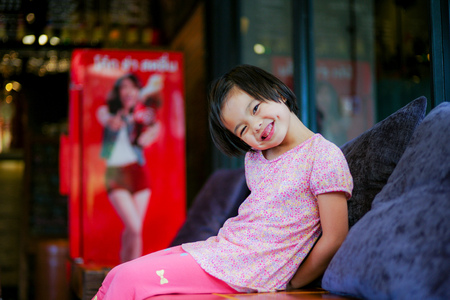 Asian little girl smiling to the camera happily and lovelyの写真素材