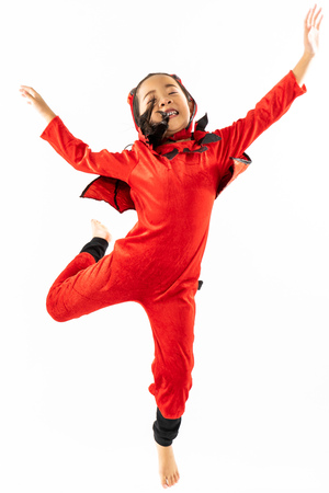 Portrait Asian little cute girl in evil costume for Halloween festival with pumpkinの写真素材