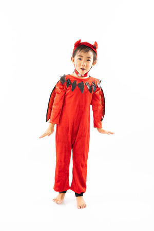 Portrait Asian little cute girl in evil costume for Halloween festival with pumpkinの写真素材