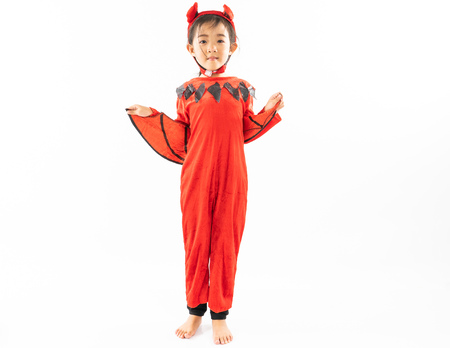 Portrait Asian little cute girl in evil costume for Halloween festival with pumpkinの写真素材