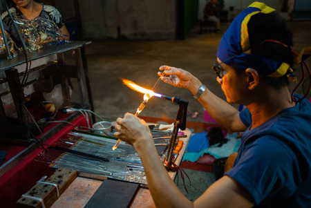 Hua Hin, Thailand:October 24, 2018 - The worker is making the craftsmanship product by melting and blowing the glass barsのeditorial素材