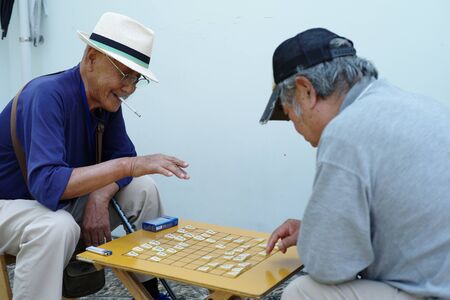 Nagasaki, Japan:August 31, 2016- Portrait crowd elder people playing Japanese chess at public park for hobby and meeting together. Activity for healing alzheimer syndom.のeditorial素材