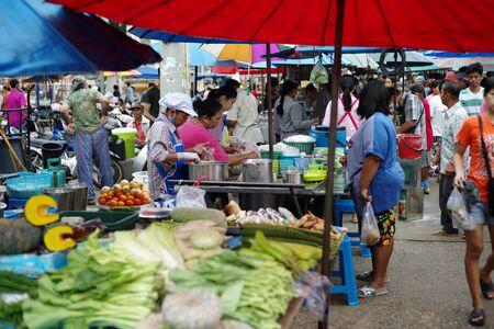 Landscape and vibe of fresh morning market in urban area of Thailand. Crowd of people shopping in the morning flea market.のeditorial素材