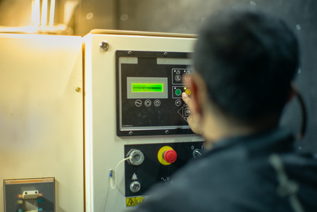 Blurred portrait of technician doing the preventive maintenance in the control room. Workers...
