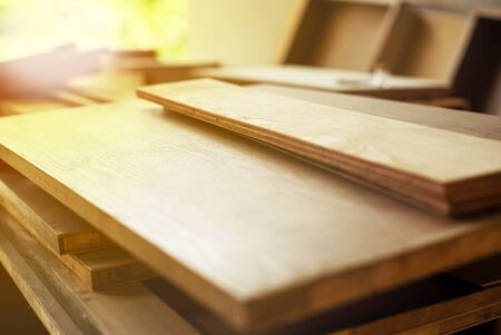Selective focus on pile of wooden boards for installing the interior work at the construction siteの写真素材