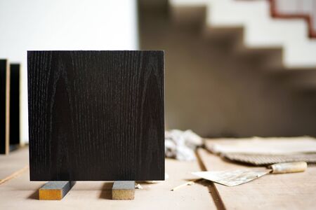 Closeup black wooden board in square shape on the stand.の写真素材