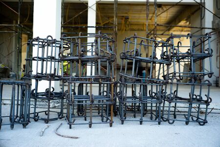 Steelwork of reinforcement steel for concrete structure at the construction site. House under construction with steel in foreground.の写真素材