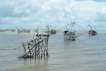 Seascape with traditional fishing tools in the sea with skyline in backgroundの写真素材