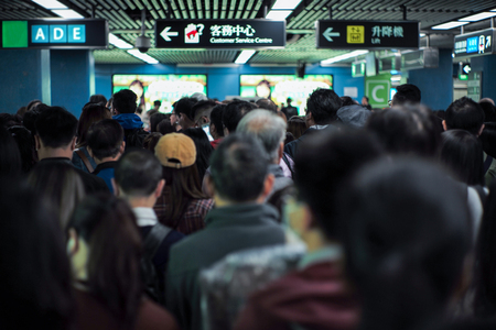 Back portrait crowd of passengers waitng for entering at the entrance of subway station during rush hours in morningのeditorial素材