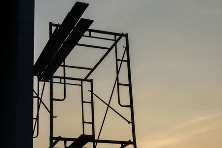 Silhouette steel scaffolding with twilight sky background at the constrcution siteの写真素材