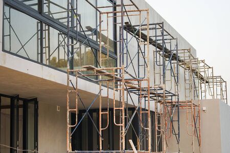 Closeup crowd of steel scaffolding set up at construction siteの写真素材