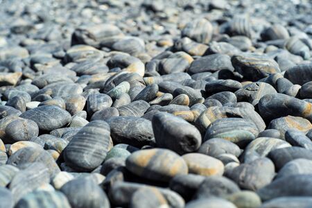 Closeup group of polished stone on the ground in sunny dayの写真素材