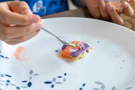 Selective focus on the little sugar balls on the cookie during bakery workshop at homeの写真素材