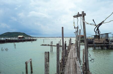 Native fisherman house and traditional fishing farm at the coast of sea with old wooden walkwayの写真素材