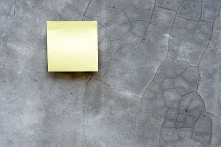 Top view reminder yellow sheet isolated on concrete backgroundの写真素材