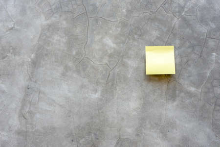 Top view reminder yellow sheet isolated on concrete backgroundの写真素材