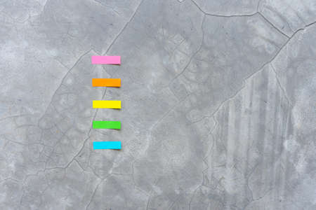 Top view colorful reminder sheets isolated on concrete  background