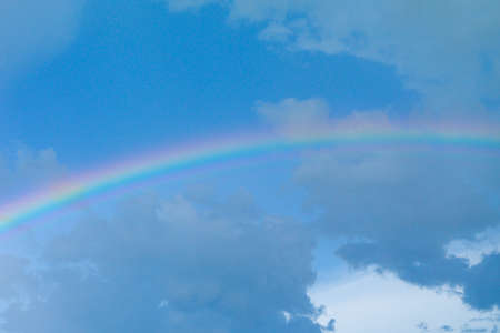 Abstract background of rainbow after raining with blue sky backgroundの写真素材