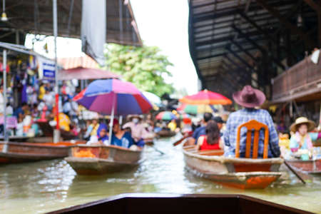 Defocused picture crowded of paddle boats with tourists in the floating market at Damnon Saduak, Thailand. Picture was blurred in purposeの写真素材