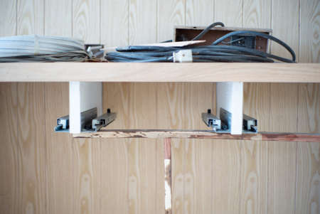 Closeup the the space for installing the wooden shelf in the room with blurred wooden board backgroundの写真素材