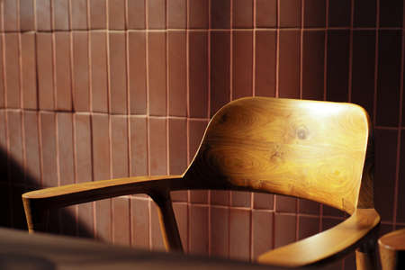 Closeup vacancy wooden chairs in vintage design in the coffee shop with the light of sunset from...