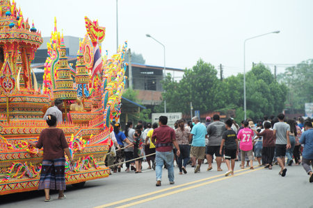 Songkhla,Thailand:October 11,2022-Crowded of people help together to drag the decorated boat called Rua Phra in the Buddhism event at the south of Thailandのeditorial素材