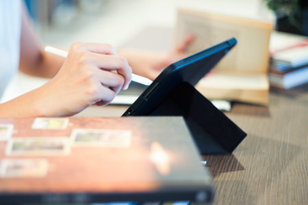 Selective focus on the hand of female officer write on the the screen of notepad by the pen with...