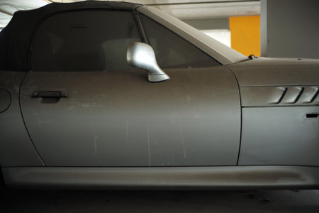 Side view of dirty super car abandoned in the parking lot