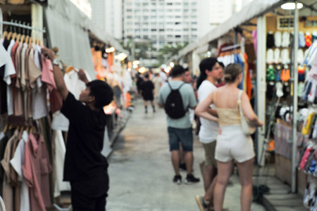 The defocused people walking in the outdoor flea market. Picture was blurred in purposeのeditorial素材