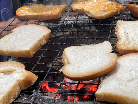 Many pieces of sliced bread grilled on the charcoal grillの写真素材
