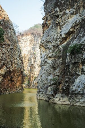 The layers of rocky cliff mountain with the lakeの写真素材