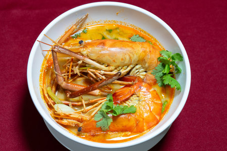 Top view closeup picture of famous Thai food called Tum Yum Kung. The big shrimp in the spicy soup.の写真素材