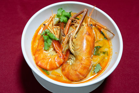 Top view closeup picture of famous Thai food called Tum Yum Kung. The big shrimp in the spicy soup.の写真素材