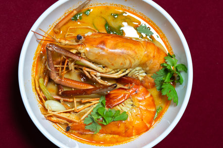 Top view closeup picture of famous Thai food called Tum Yum Kung. The big shrimp in the spicy soup.の写真素材