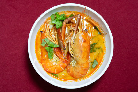 Top view closeup picture of famous Thai food called Tum Yum Kung. The big shrimp in the spicy soup.の写真素材