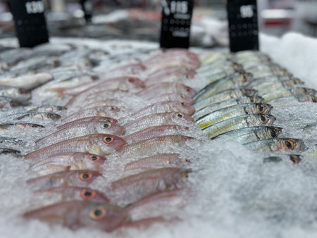 Selective focus on the fresh raw fish on the tray with ice at the food storeの写真素材