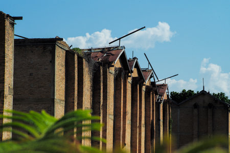 Row of old redbrick buildings in the abandoned area with blue sky backgroundの写真素材
