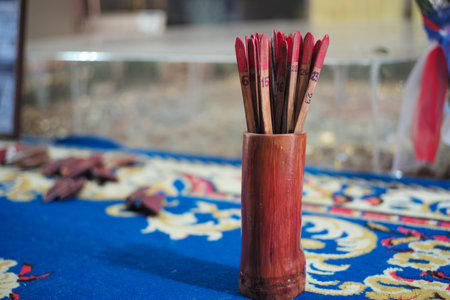 Group of wooden sticks in bamboo cup for shaking to random the number.の写真素材