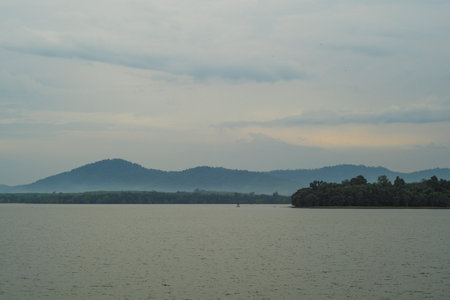 Panorama view of many layers of the mountains with the peaceful lagoon in foregroundの写真素材