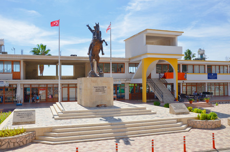 Rizokarpaso, Dipkarpaz, Northern Cyprus - October 3rd 2018: Statue of Mustafa Kemal Ataturk on a small square with shops in the background. Rizokarpaso is a small city in beautiful Karpas Peninsula.のeditorial素材
