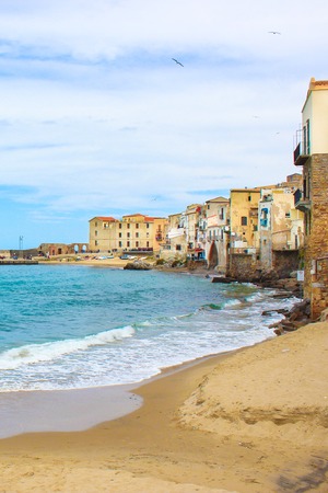 Old traditional houses in the harbour of beautiful Sicilian city Cefalu. The city located on the Tyrrhenian coast is on of the major tourist attractions in Italy.の写真素材