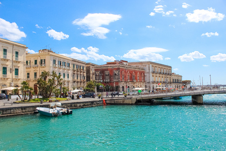 Syracuse, Sicily, Italy - Apr 10th 2019: Beautiful Sicilian harbor and bridge connecting the city of Syracuse with famous Ortigia Island. Part of UNESCO World Heritage. Popular tourist destinations.のeditorial素材