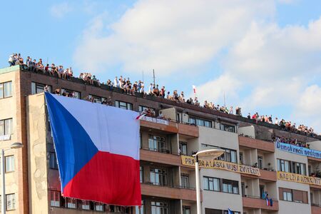 Prague, Czech Republic - June 23 2019: People on a roof of a building supporting protests against Prime Minister Babis and Minister of Justice on Letna, Letenska plan. Demonstration, czech flag.のeditorial素材