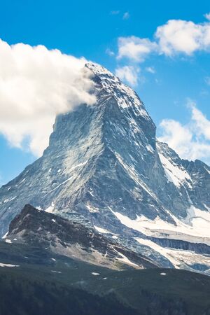 Vertical picture of famous Matterhorn mountain in Switzerland photographed from Zermatt in summer season. Swiss Alps, alpine mountains. Beautiful landscape. Steep, rocky peak.の写真素材