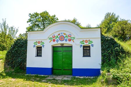 Petrov-Plze, Czech Republic - August 14 2014: Typical wine cellars in Moravia decorated with traditional slavic wine motives. Moravia wine region, tourism. Traditional buildings.のeditorial素材