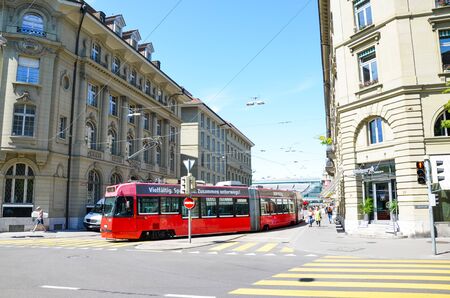 Bern, Switzerland - August 14 2019: Red tram in the city center of the Swiss capital. Red light on...